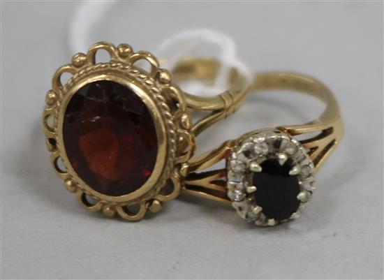 A sapphire and diamond oval cluster ring, 9ct gold setting and a 9ct gold garnet-set dress ring.